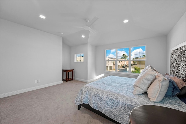 carpeted bedroom featuring ceiling fan and vaulted ceiling