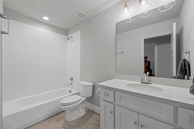 full bathroom featuring tiled shower / bath combo, vanity, and toilet