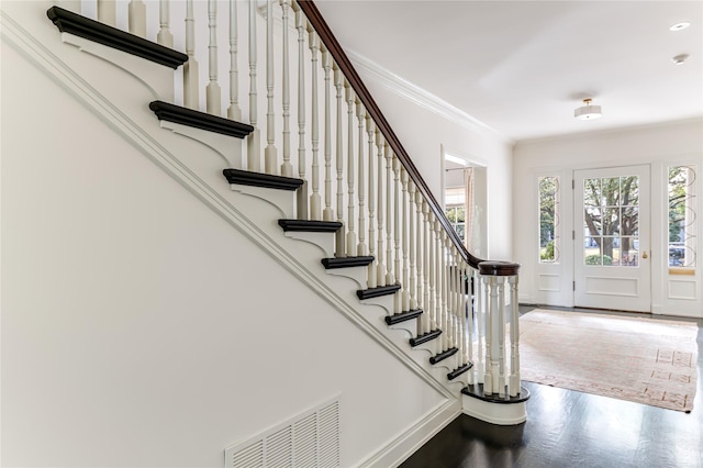 foyer featuring ornamental molding and wood-type flooring