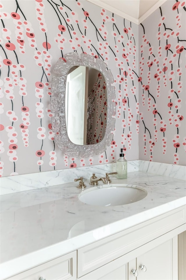 bathroom with vanity and ornamental molding