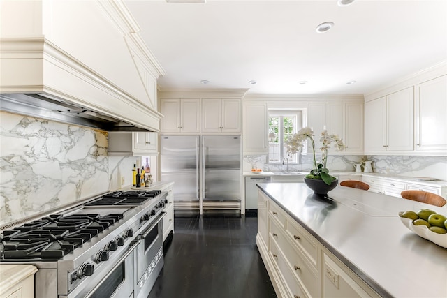 kitchen with high quality appliances, custom exhaust hood, and backsplash