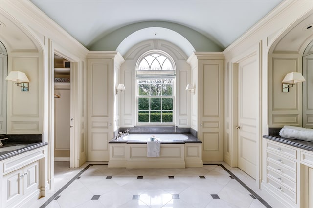 bathroom with vanity, tile patterned floors, and a tub to relax in