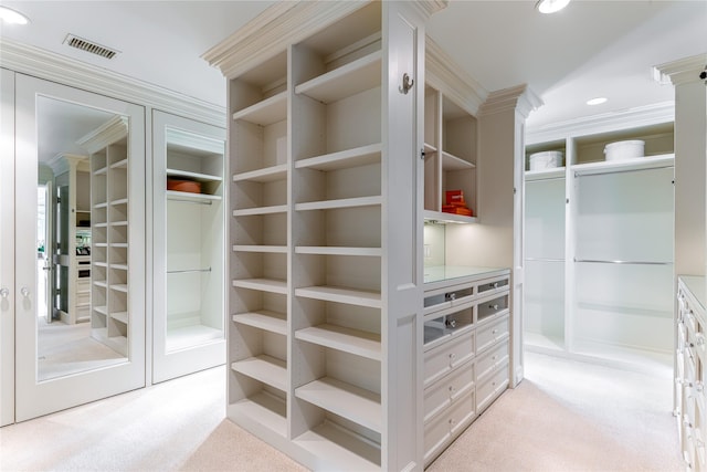 spacious closet featuring light carpet