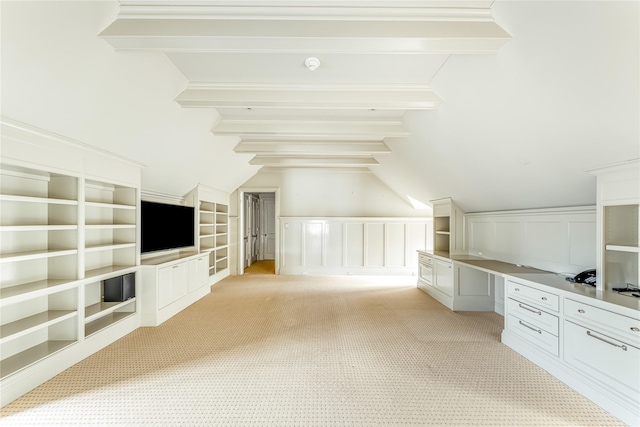 bonus room featuring built in shelves, built in desk, and light carpet