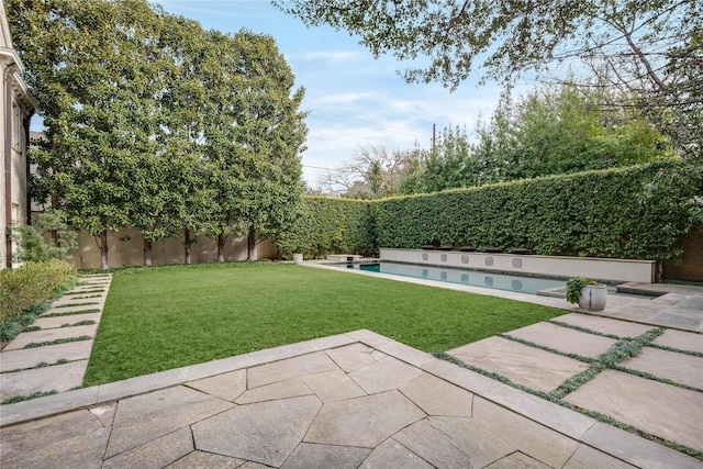 view of yard featuring a fenced in pool and a patio