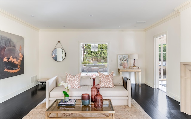 living room with hardwood / wood-style flooring, crown molding, and a healthy amount of sunlight