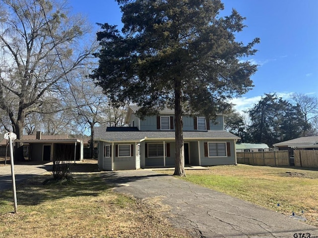 view of front of property with a front yard and a carport