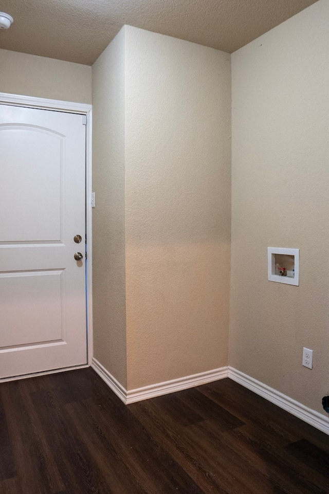 washroom featuring washer hookup, a textured ceiling, and dark hardwood / wood-style flooring