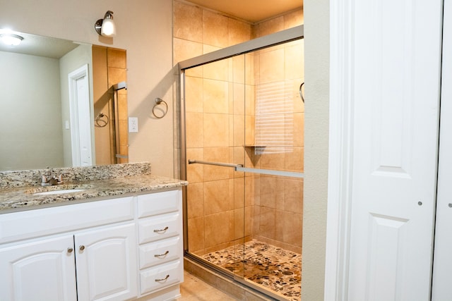 bathroom featuring vanity and an enclosed shower