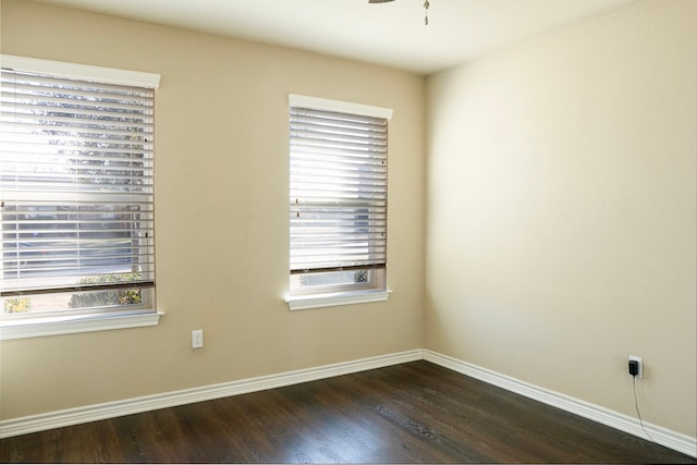 unfurnished room featuring ceiling fan and dark hardwood / wood-style floors