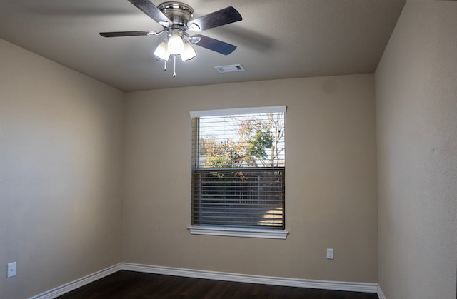 empty room featuring ceiling fan and dark hardwood / wood-style floors