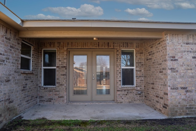 entrance to property featuring a patio area and french doors