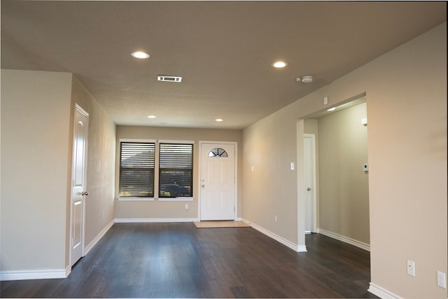 entryway with dark hardwood / wood-style flooring