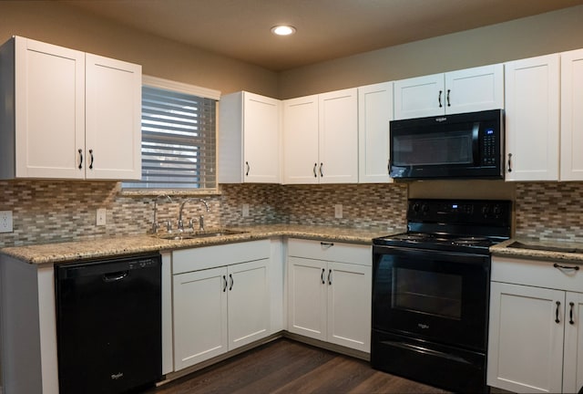 kitchen with white cabinets, sink, decorative backsplash, and black appliances