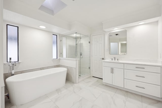 bathroom with vanity and shower with separate bathtub