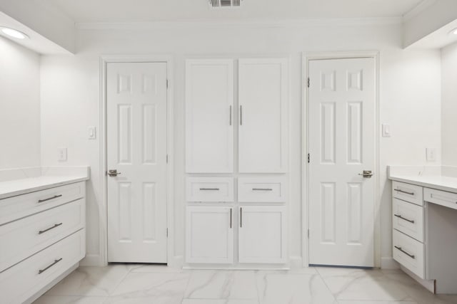 bathroom with ornamental molding and vanity