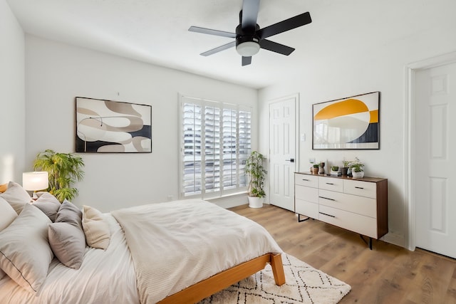 bedroom with light wood-type flooring and ceiling fan