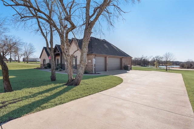 view of side of home featuring a garage and a lawn