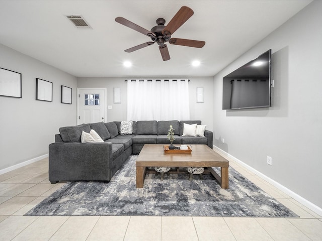 tiled living room with ceiling fan