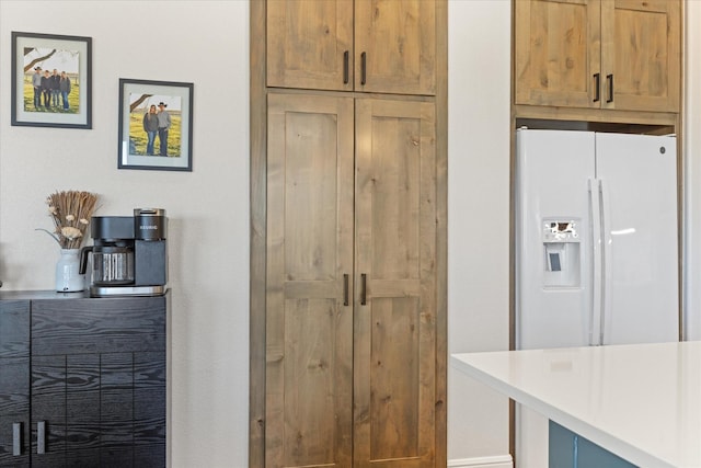 kitchen with white refrigerator with ice dispenser