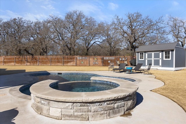 view of pool with an outdoor structure, a patio, and an in ground hot tub