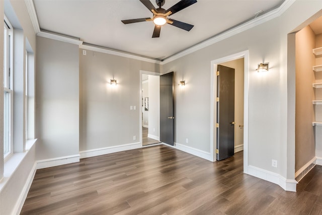 spare room featuring dark hardwood / wood-style flooring, crown molding, and ceiling fan