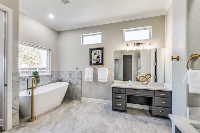 bathroom with vanity, ornamental molding, a tub, and tile walls