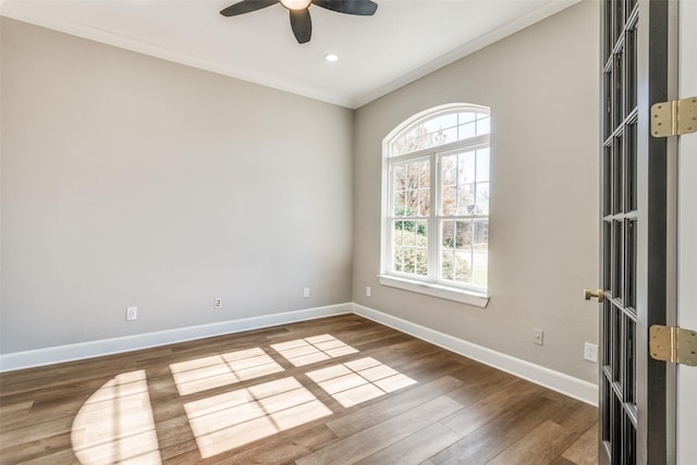 unfurnished room featuring wood-type flooring, ornamental molding, and ceiling fan