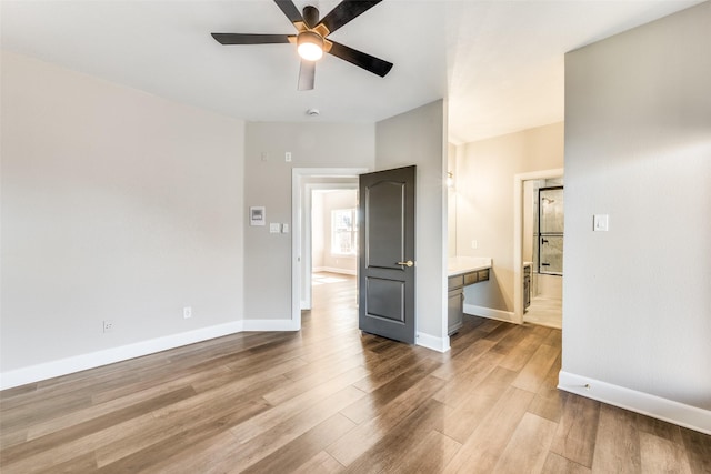 empty room featuring ceiling fan and light hardwood / wood-style flooring