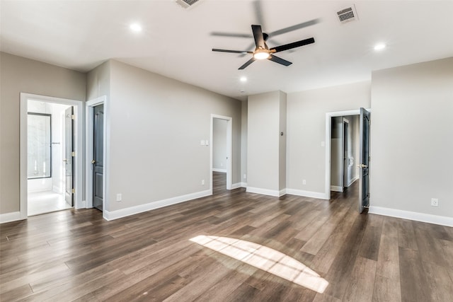 unfurnished living room with dark hardwood / wood-style flooring and ceiling fan