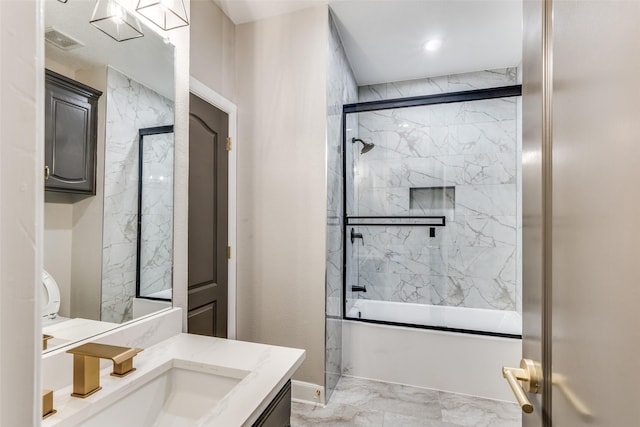 bathroom with vanity and bath / shower combo with glass door