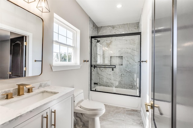 full bathroom featuring vanity, toilet, and combined bath / shower with glass door