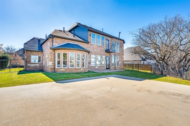 rear view of property featuring a patio and a lawn