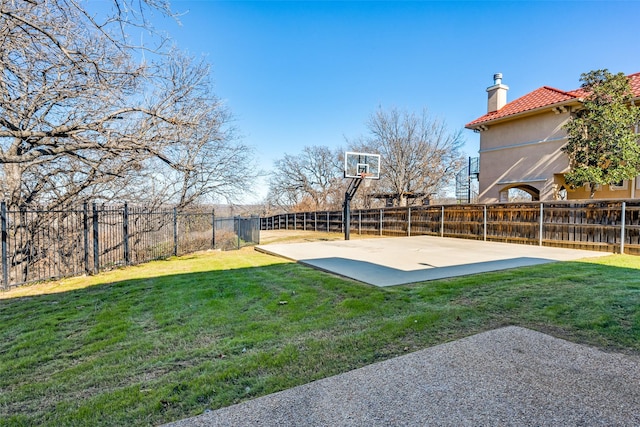 view of basketball court featuring a lawn