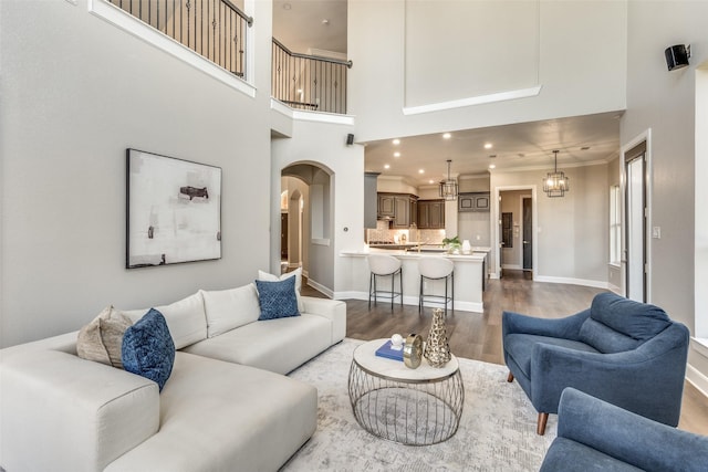 living room with light hardwood / wood-style flooring and a high ceiling