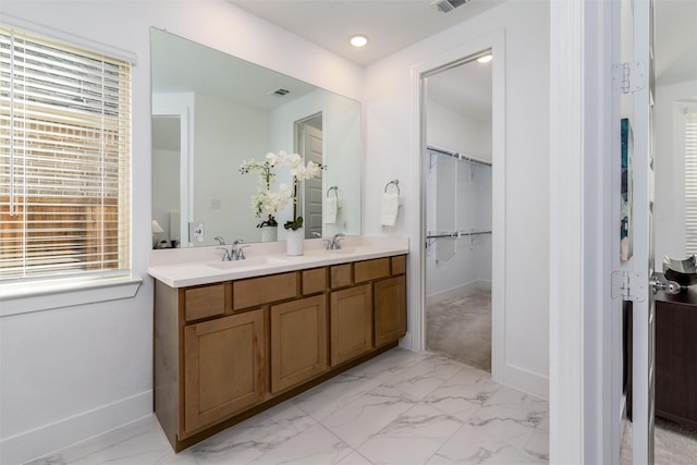 bathroom with marble finish floor and baseboards