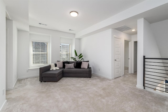 sitting room with light carpet, baseboards, and an upstairs landing