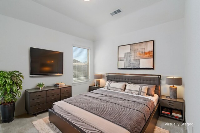 carpeted empty room featuring lofted ceiling