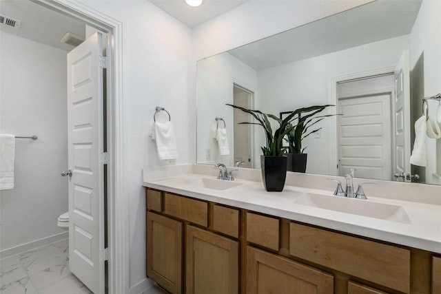 bathroom featuring vanity and toilet