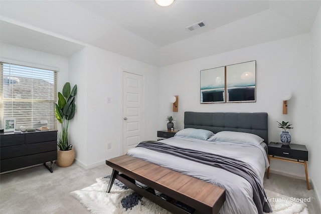 unfurnished room featuring light colored carpet, visible vents, and baseboards