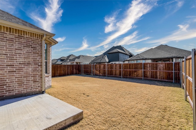 view of yard featuring a patio area and a fenced backyard