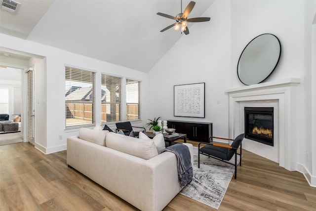 kitchen with light countertops, visible vents, stainless steel dishwasher, open floor plan, and a sink