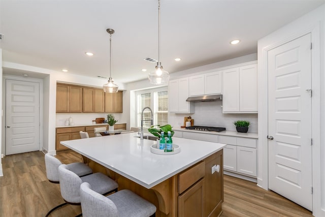 dining space with baseboards, visible vents, and wood finished floors