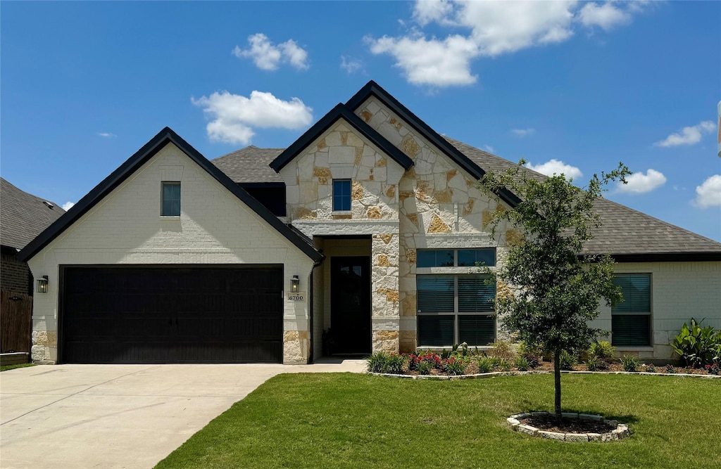 french provincial home featuring a front yard