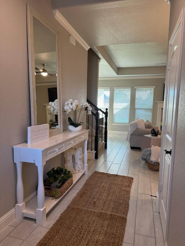 corridor featuring ornamental molding and light tile patterned floors