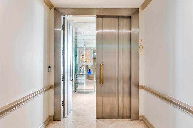 hallway featuring crown molding and elevator