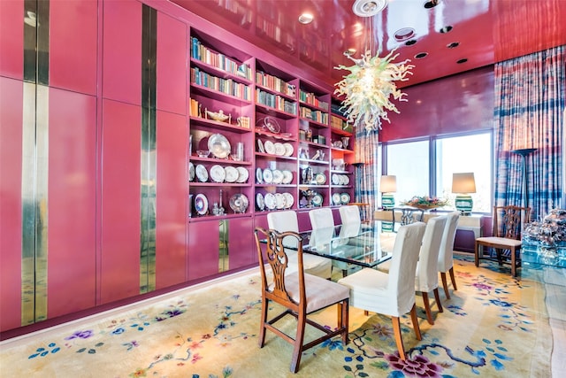 dining room with built in features and an inviting chandelier