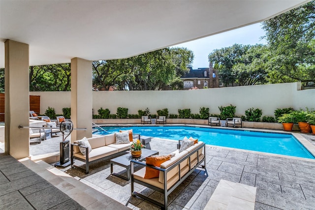 view of swimming pool with an outdoor living space and a patio area