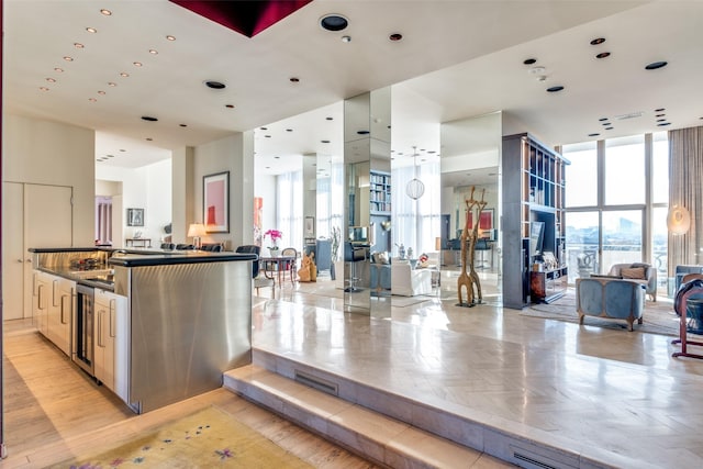 kitchen with floor to ceiling windows, light parquet flooring, wine cooler, and kitchen peninsula