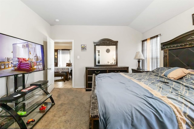 carpeted bedroom with lofted ceiling